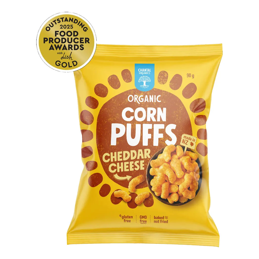 Packaging of organic corn puffs with cheddar cheese flavor on a white background