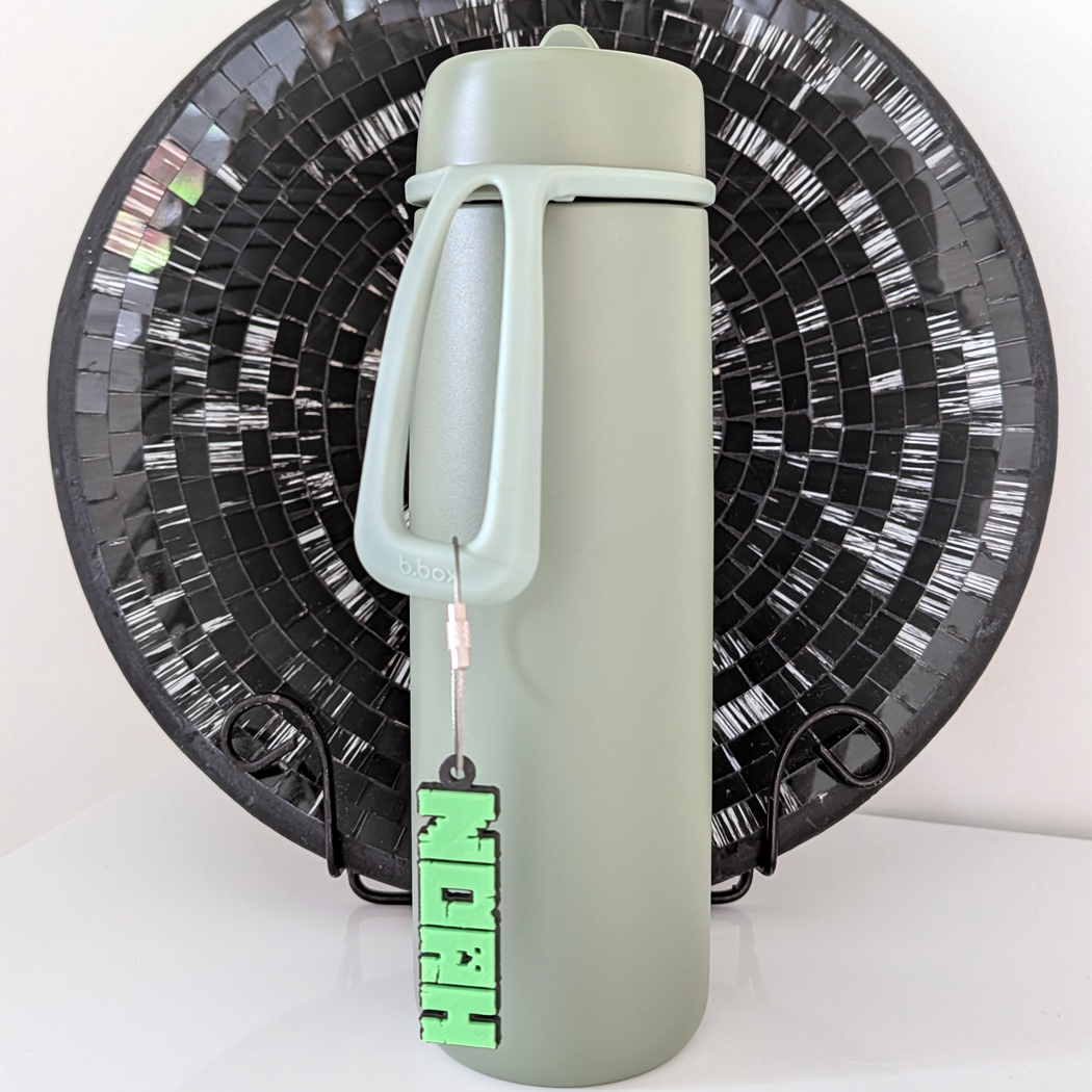 Gray water bottle with a green label on a white background