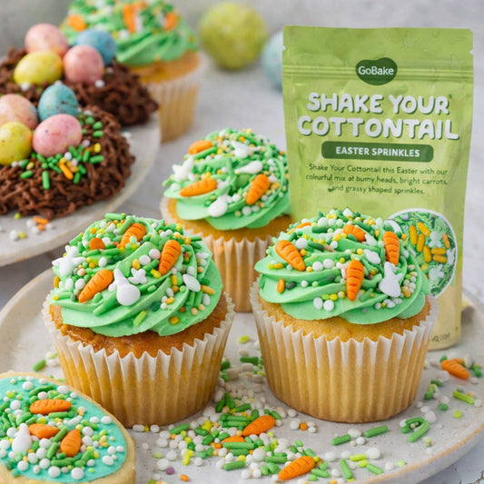 Easter-themed cupcakes with green frosting and sprinkles, accompanied by 'GoBake' sprinkles packaging.