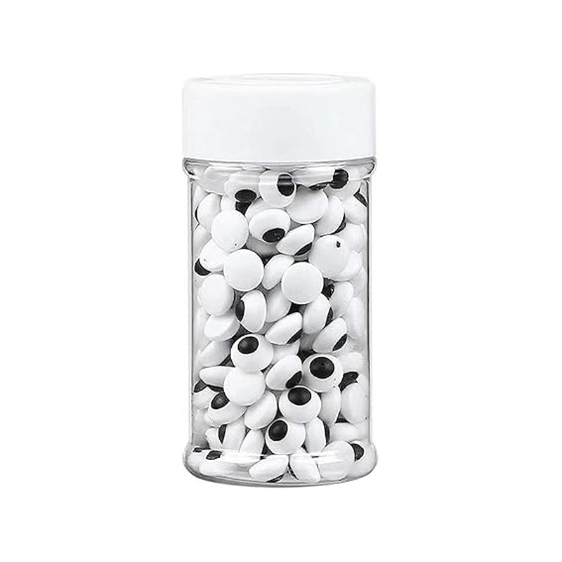 Jar filled with small white and black eyes on a white background