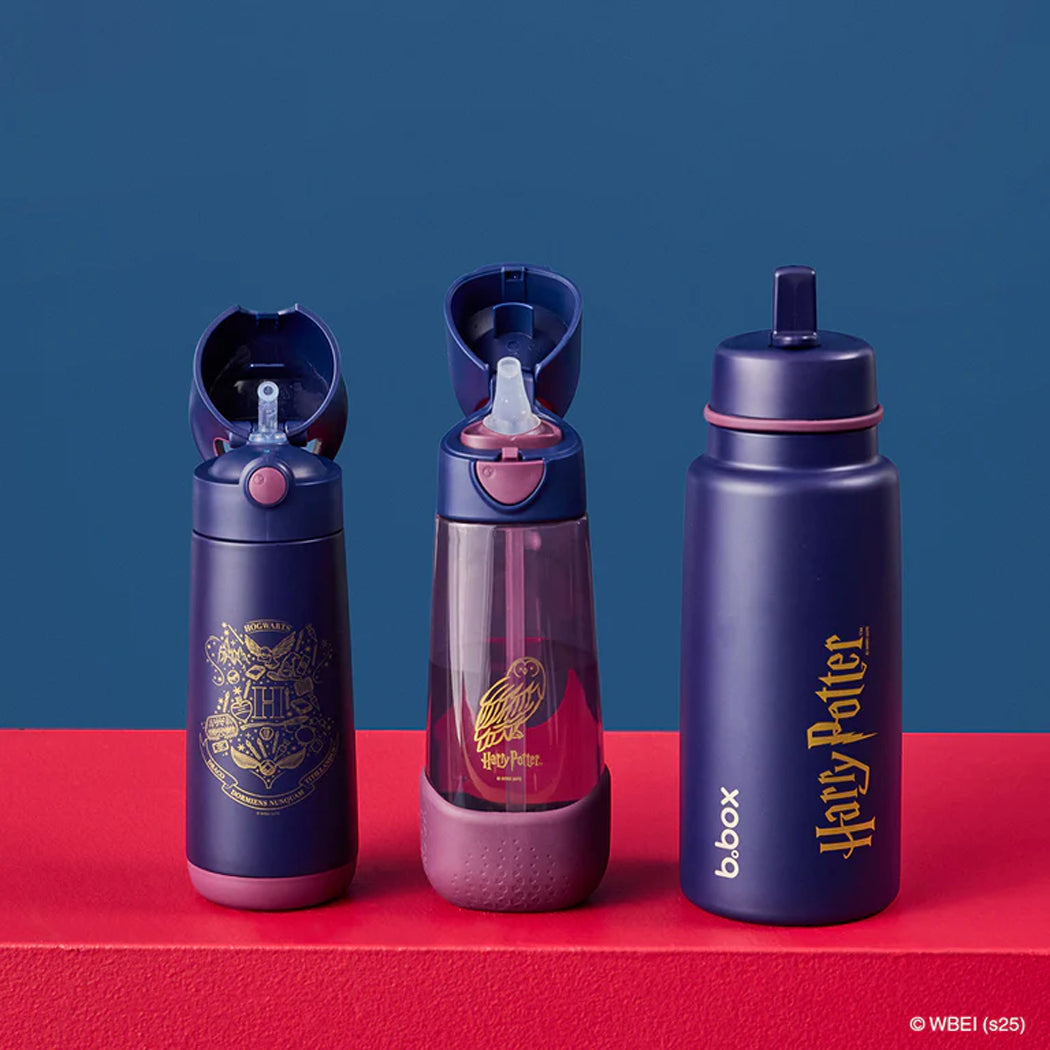 Three Harry Potter-themed water bottles on a red and blue background