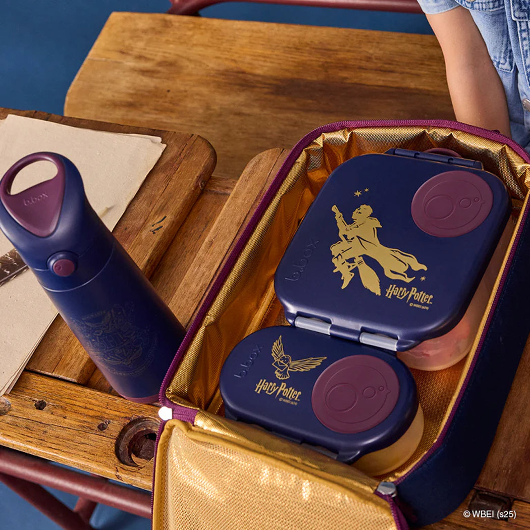 Harry Potter-themed lunch box and bottle set on a wooden table