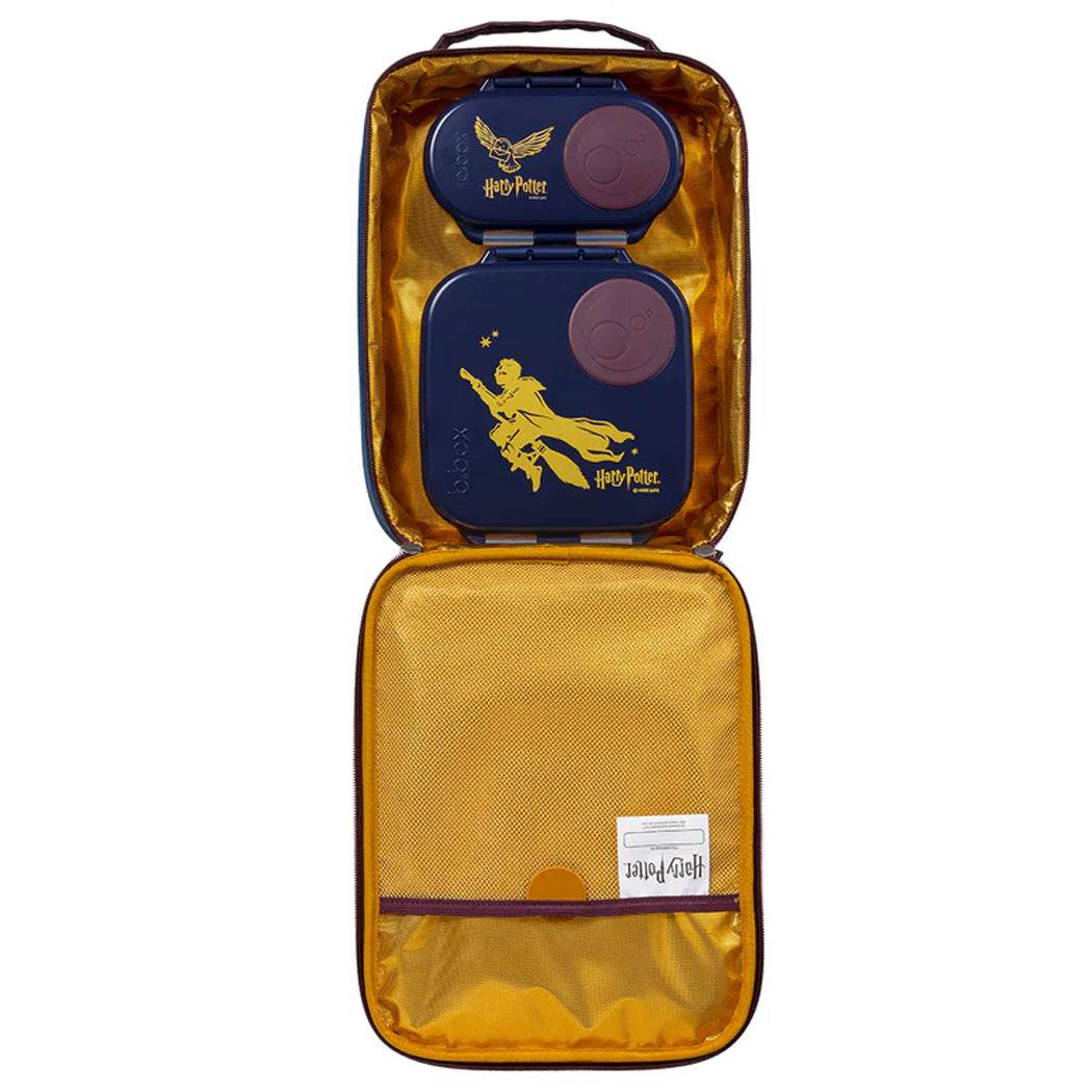 Open yellow travel case with Harry Potter-themed items on a white background