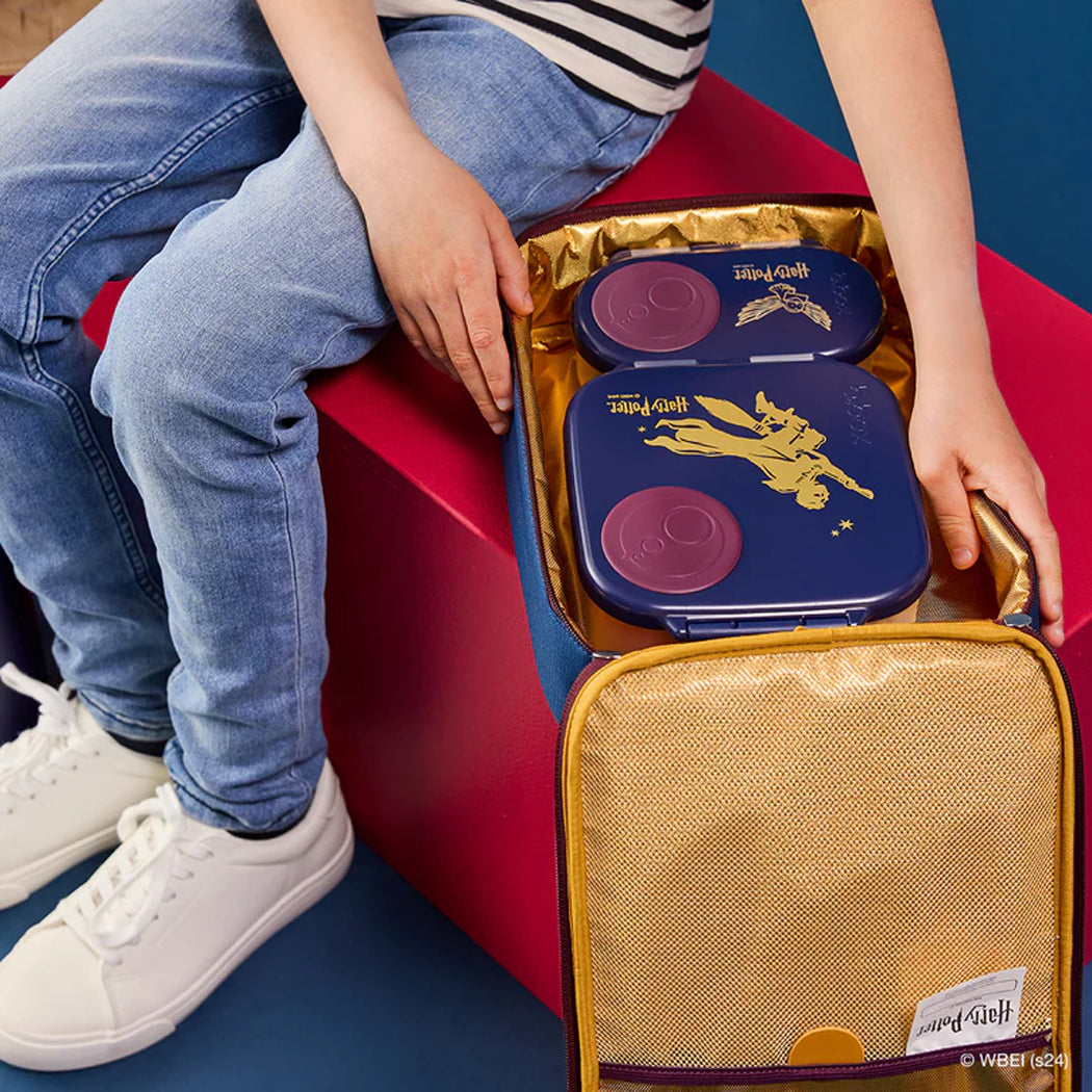 Person opening a lunch bag with a branded design on a red and blue background