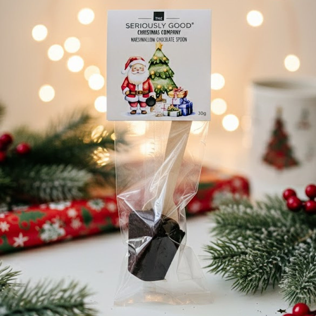Chocolate spoon in a clear bag with a festive label against a Christmas-themed background