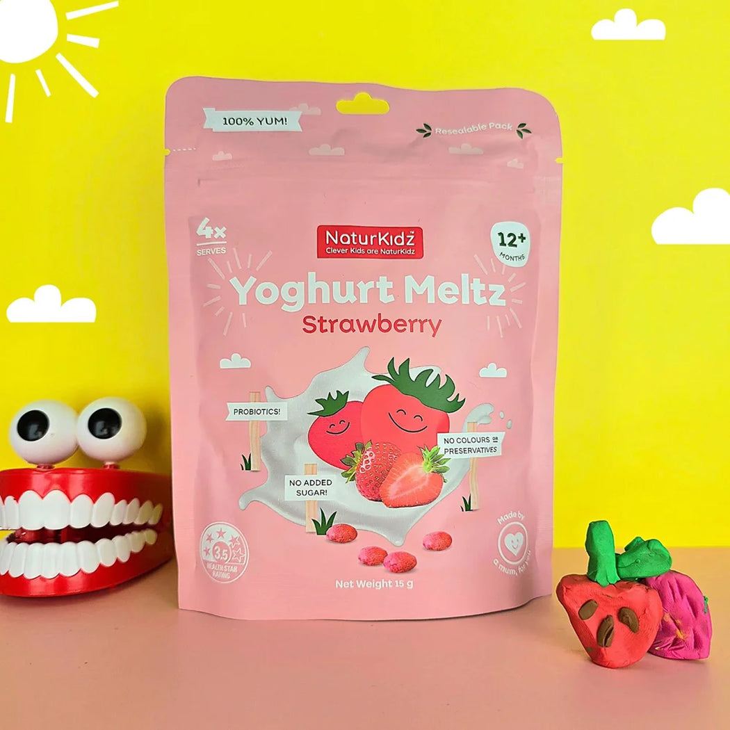 Pink package of NaturKidz Strawberry Yoghurt Meltz with a red toy mouth and strawberry-shaped toy on a yellow background