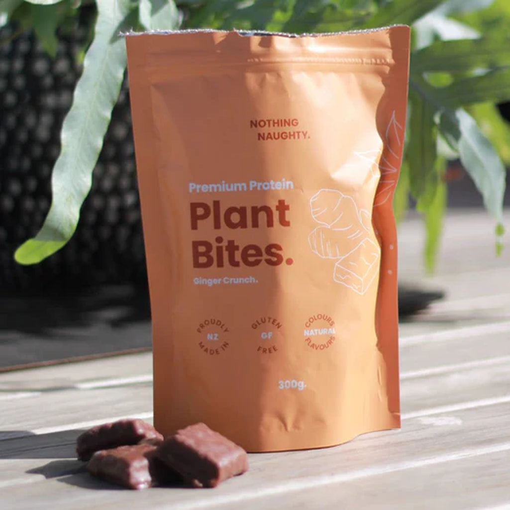 Package of 'Plant Bites' protein snacks on a wooden surface with plants in the background