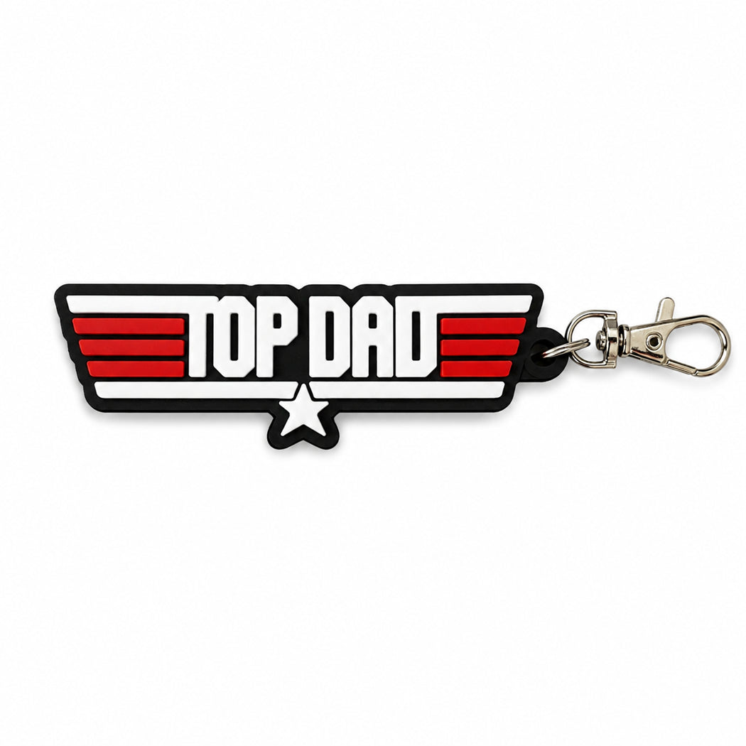 A rubber keychain featuring the words 'TOP DAD' in bold white letters with red stripes and a black outline, complete with a silver lobster clasp on a white background.