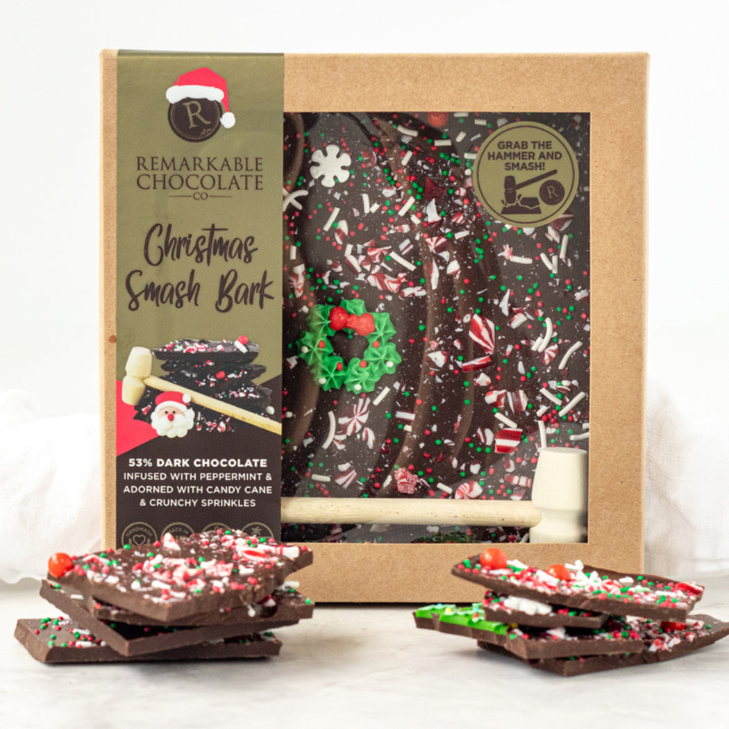 Christmas Smash Bark with packaging and candy canes on a white background