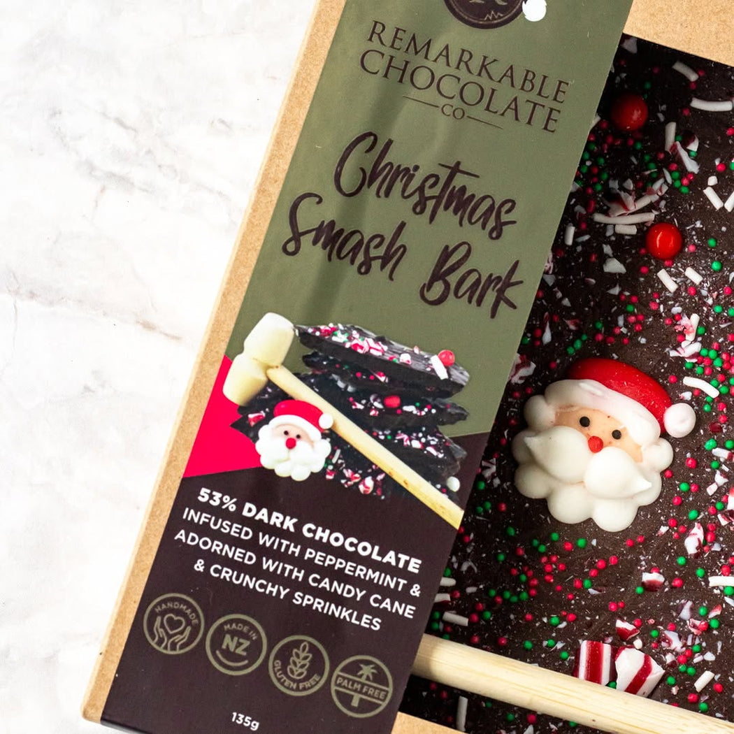 Christmas-themed chocolate bark with a 'Remarkable Chocolate Co' packaging on a white background