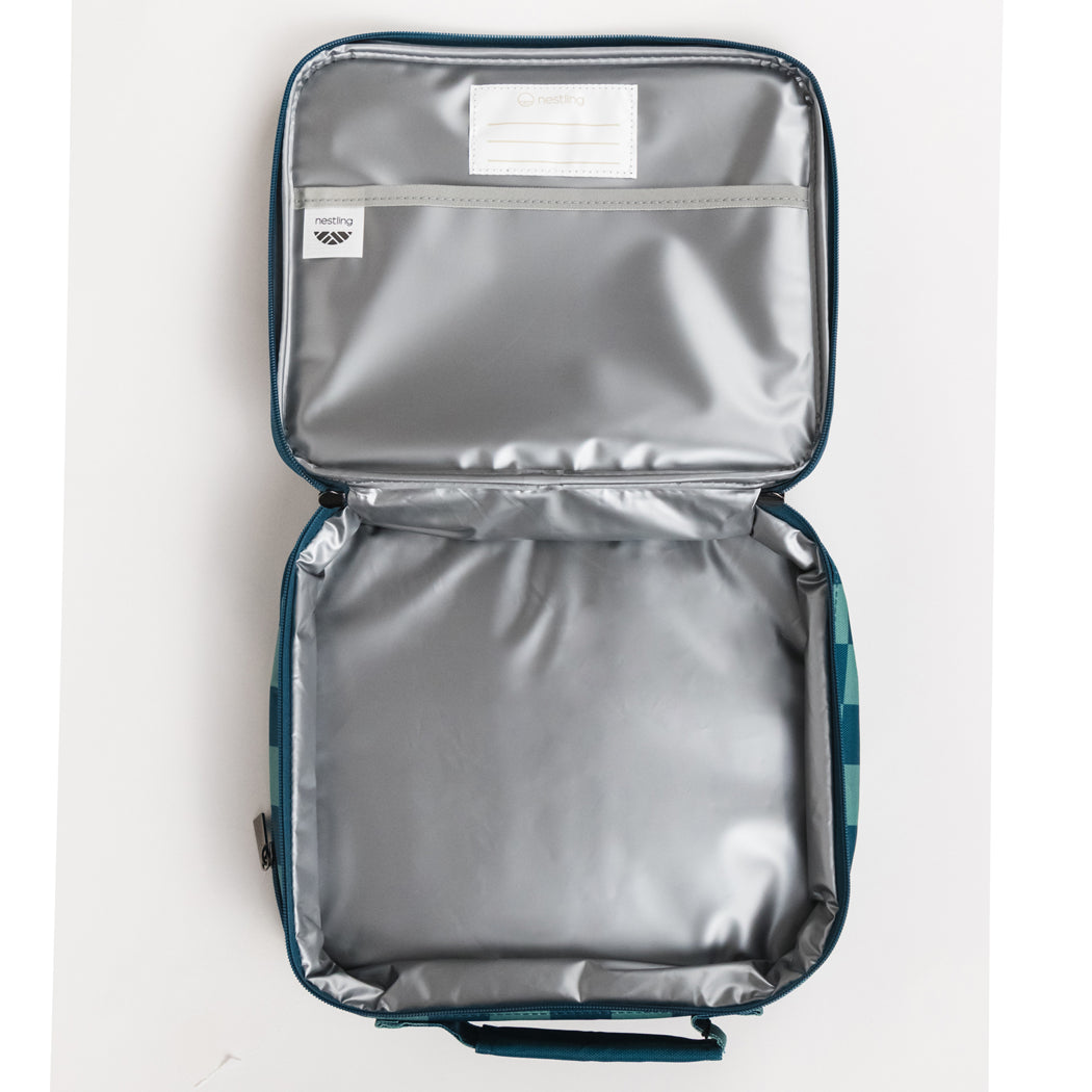 An open soft-sided cooler bag or lunch bag with a metallic silver insulated interior and dark teal-blue exterior trim, shown against a plain white background.