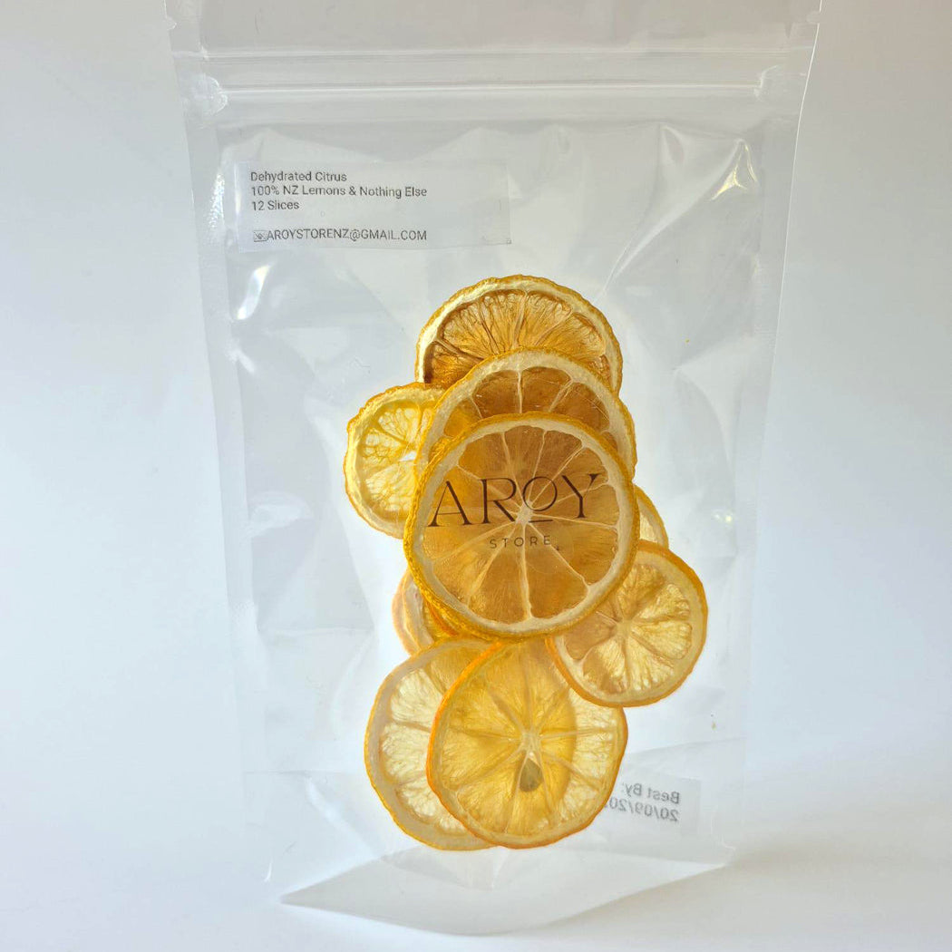 A clear resealable pouch containing dried lemon slices, with the brand name AROY printed on the center slice. The pouch is photographed against a plain white background.