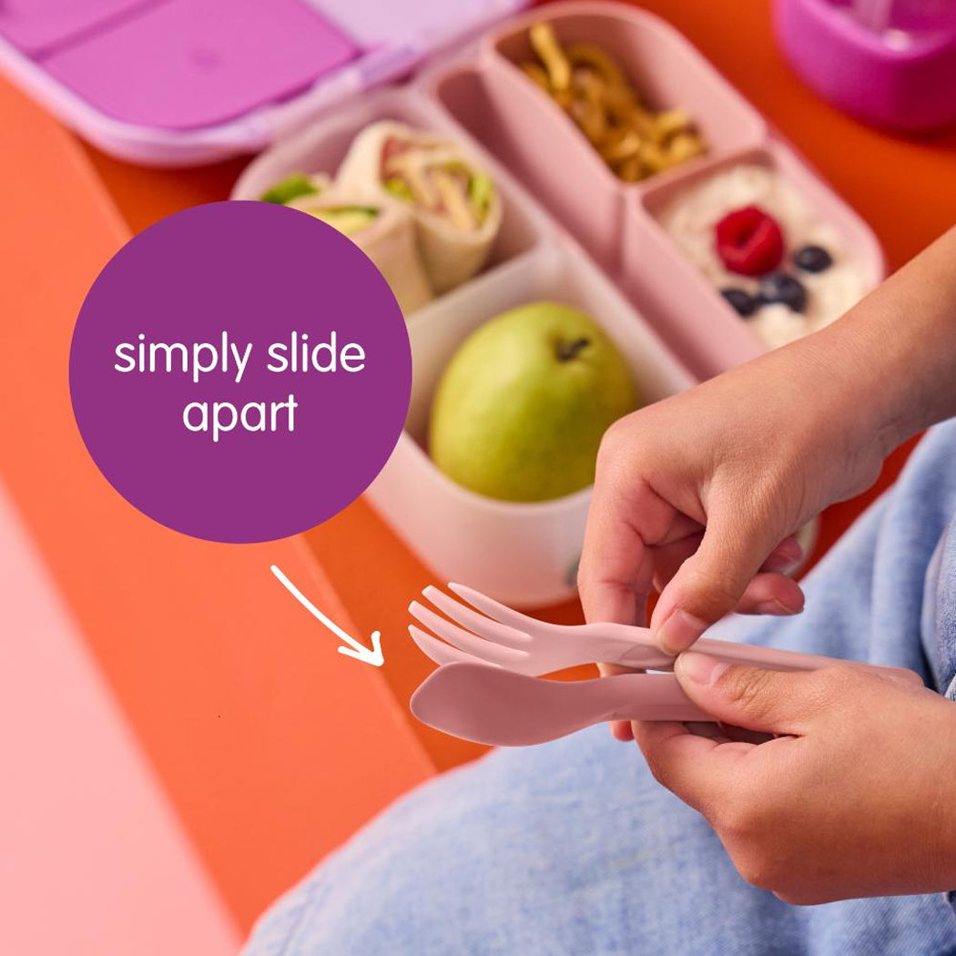 Children's lunchbox with compartments, hands holding cutlery, and text 'simply slide apart'.
