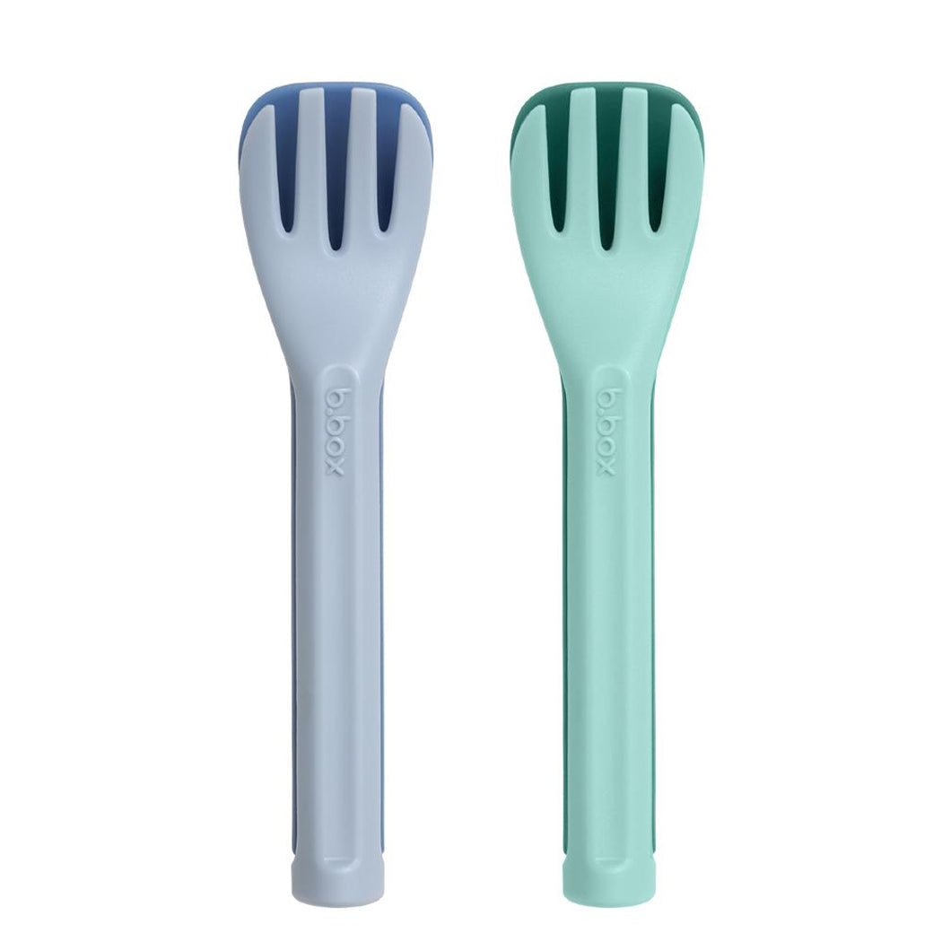Two salad servers, one gray and one green, on a white background