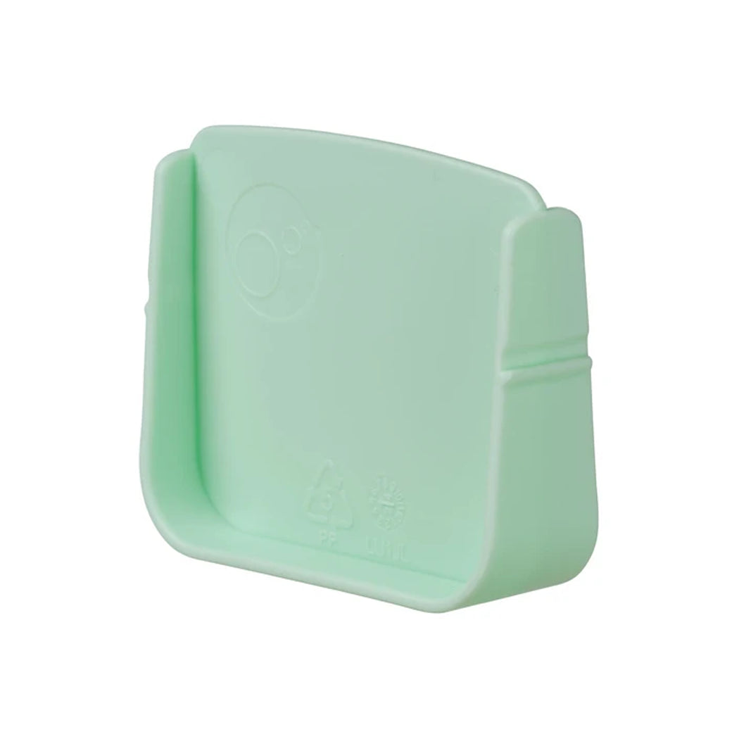 A mint green plastic accessory, likely a protective cap or cover, shown on a plain white background.