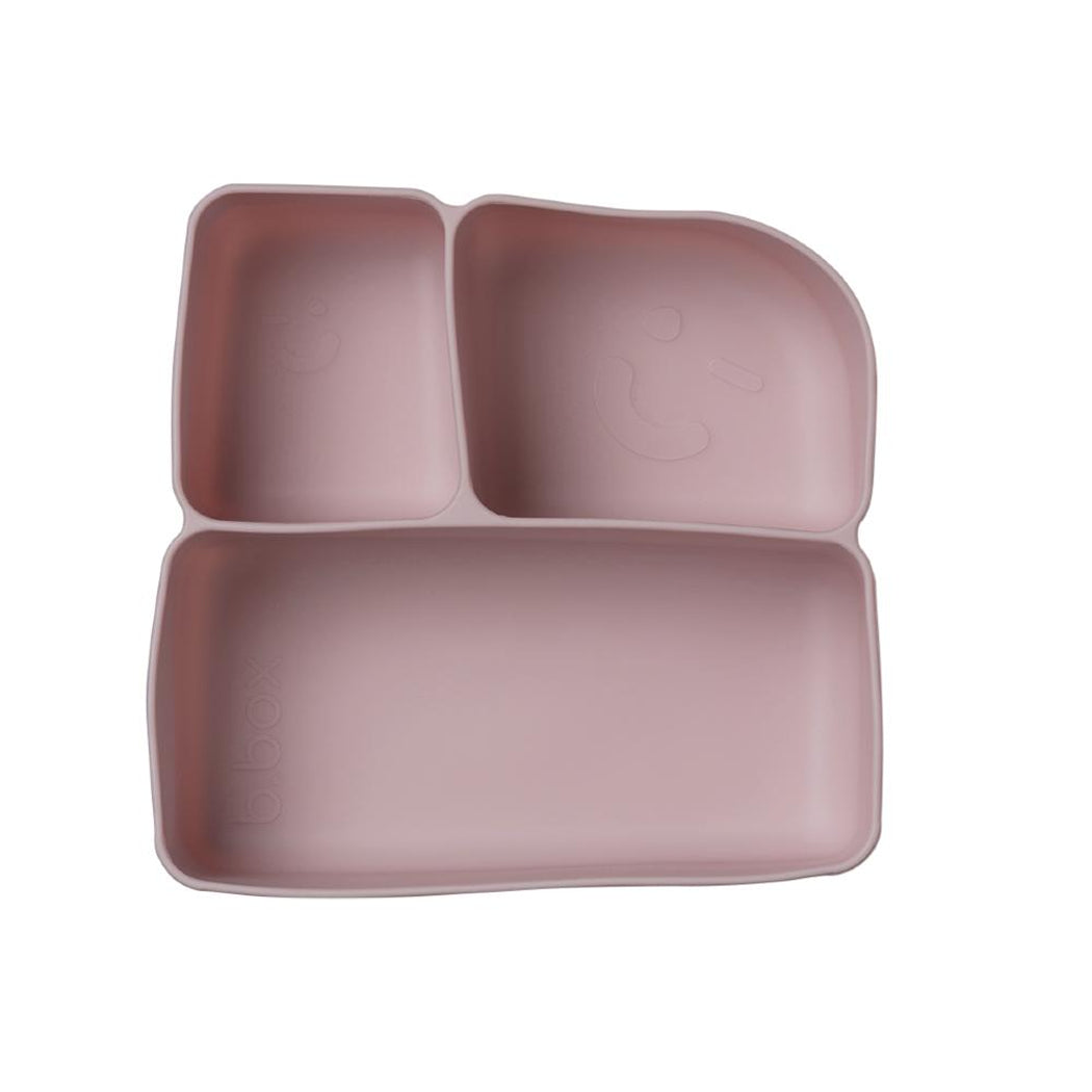 Pink silicone mat with divided sections on a white background