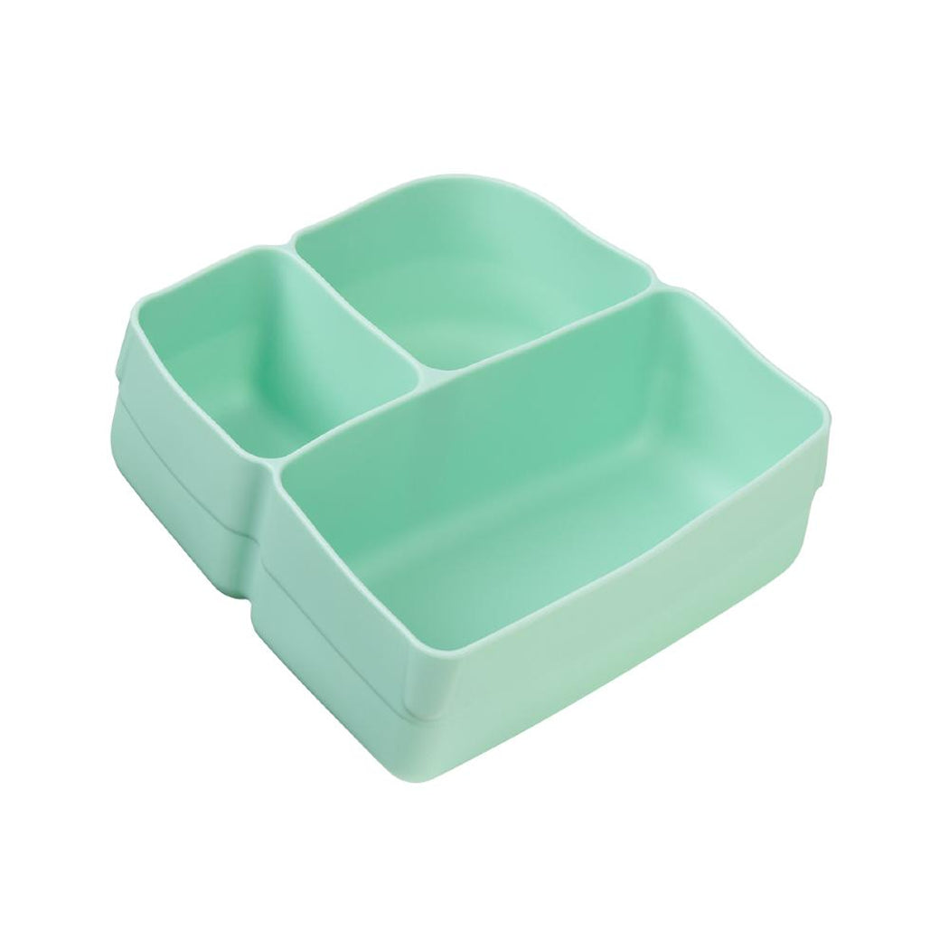 Stack of three green divided trays on a white background
