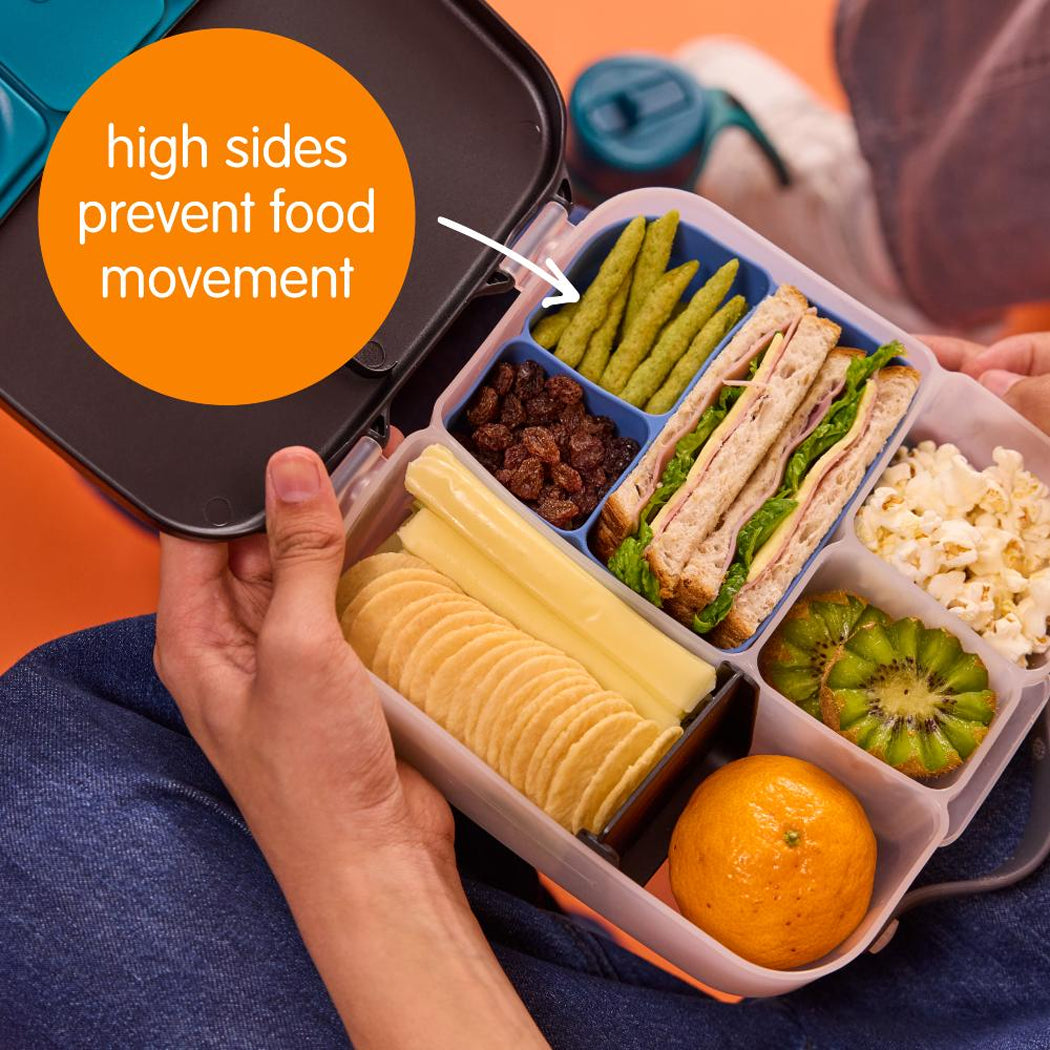 Bento box with compartments of food held by a person, with an orange label indicating high sides prevent food movement.