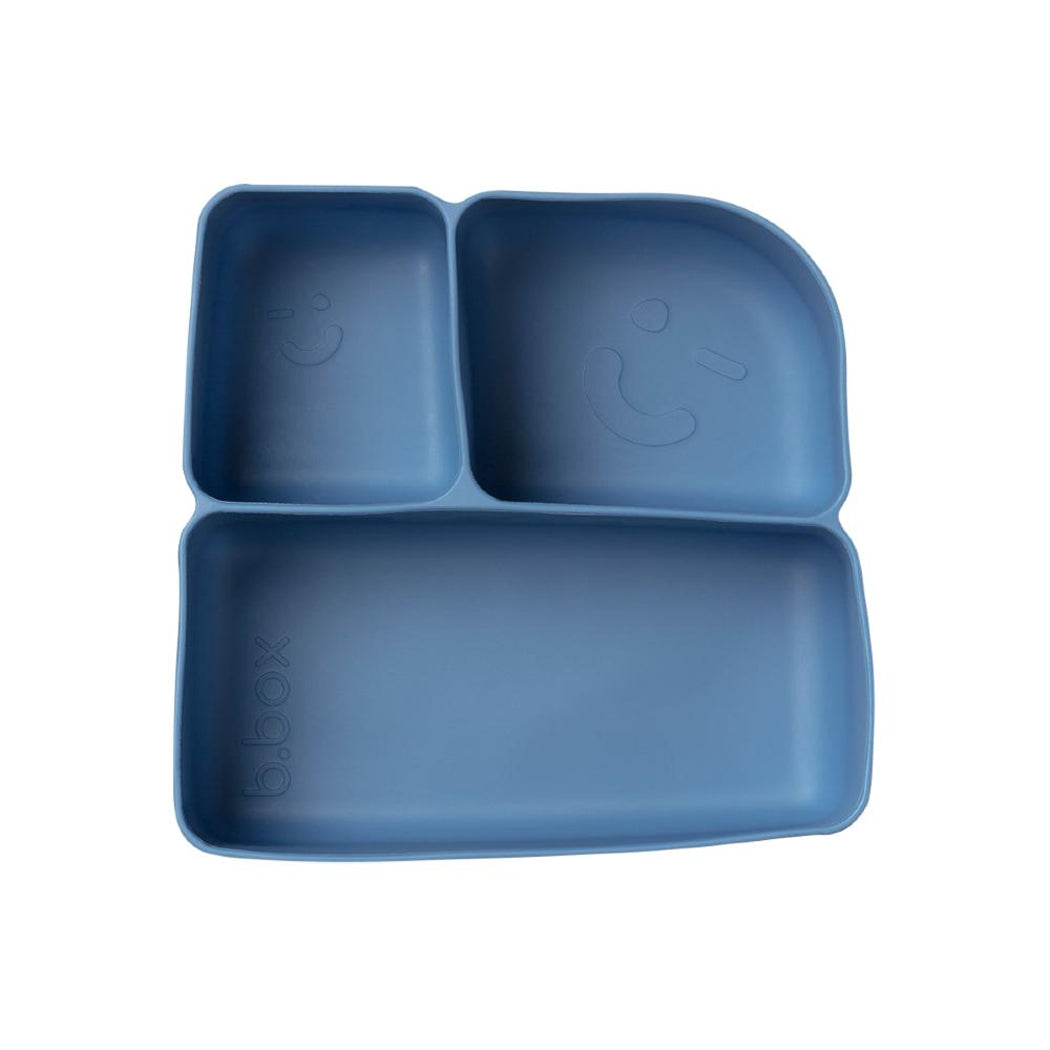 Blue silicone placemat with divided sections on a white background