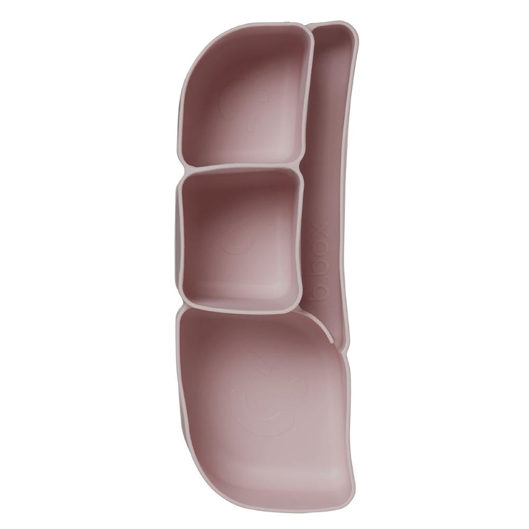 Pink silicone container with compartments on a white background