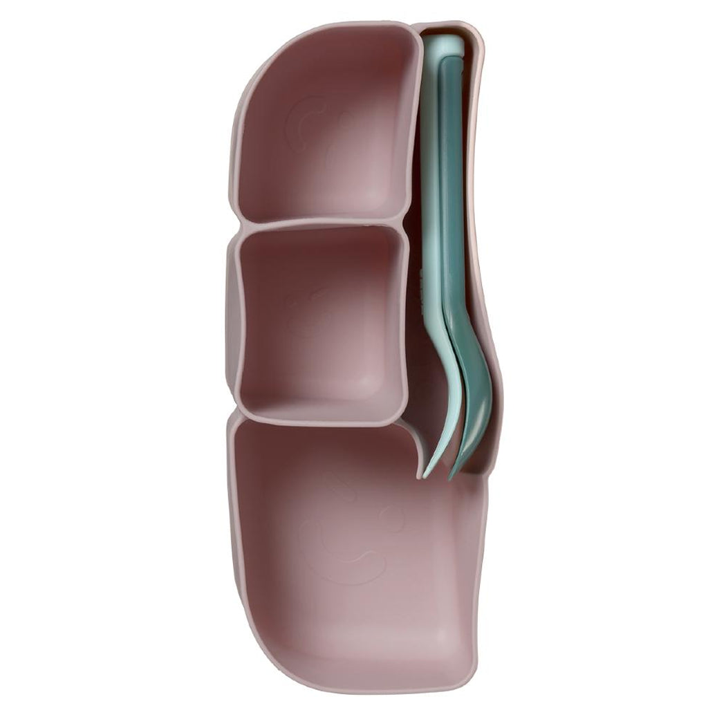 Pink and green silicone container with compartments on a white background