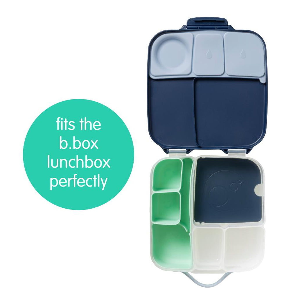 Navy blue and green bento box with compartments on a white background