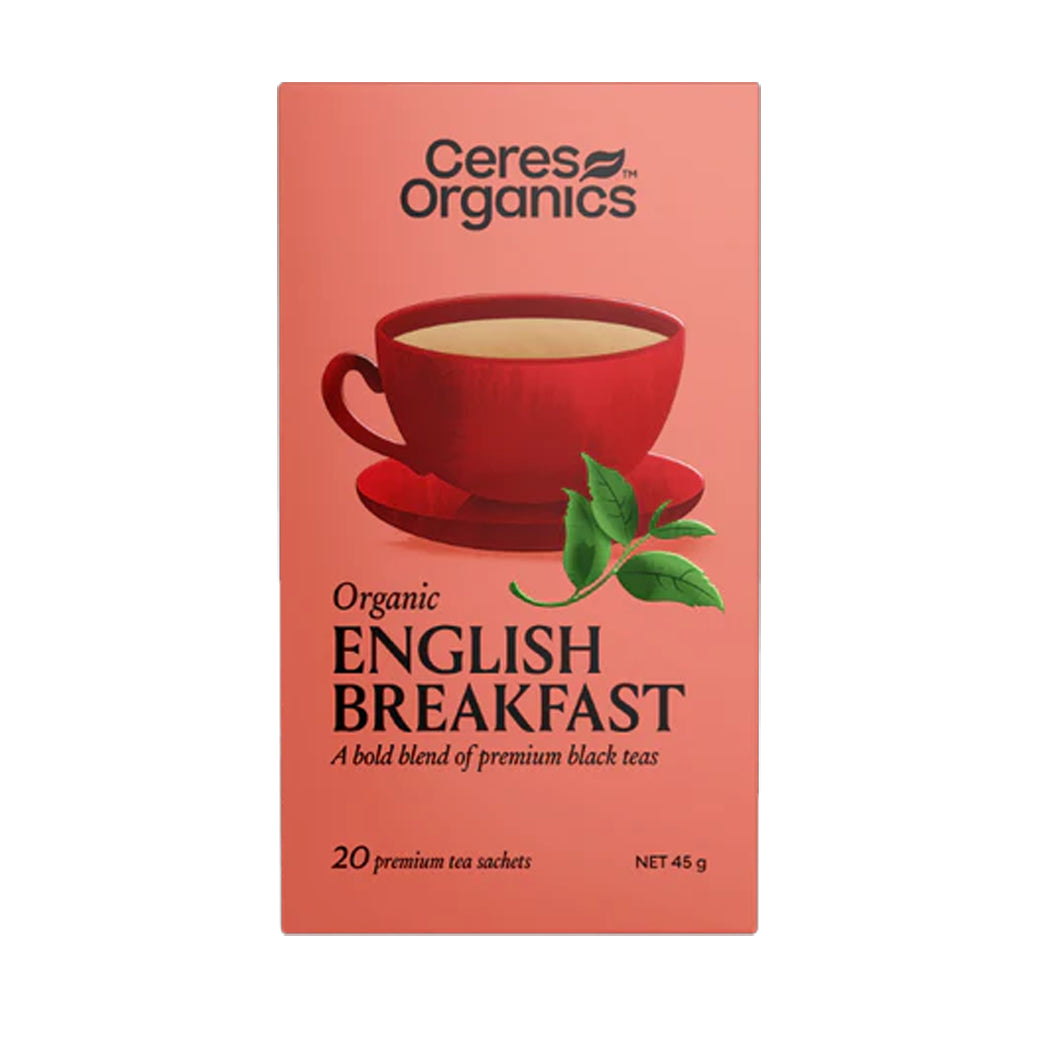 Ceres Organics English Breakfast tea package with a red cup and green leaves on a pink background