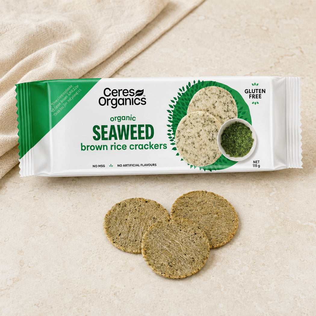 A package of Ceres Organics Organic Seaweed Brown Rice Crackers is displayed on a light beige textured surface next to three loose round crackers.