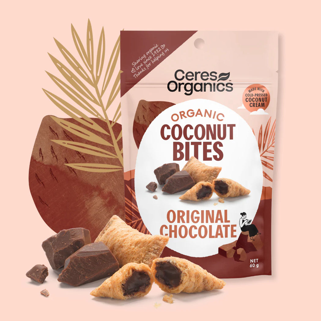 Ceres Organics Organic Coconut Bites packaging with cookies and chocolate pieces on a pink background