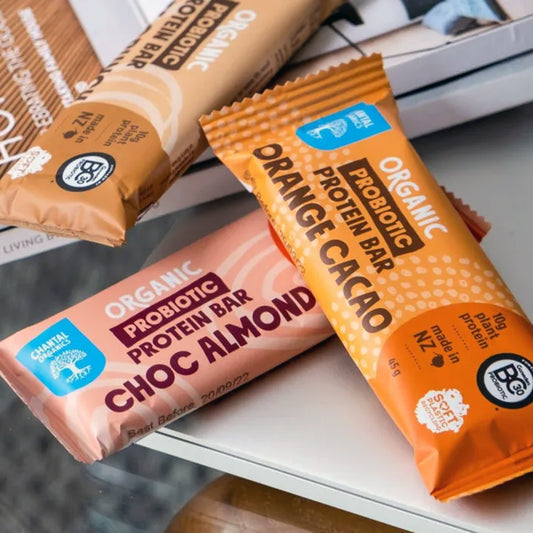 Three organic probiotic protein bars on a surface