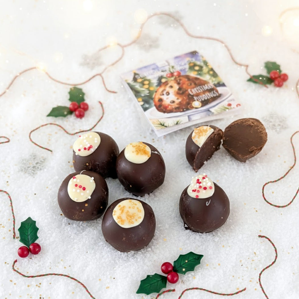 Chocolate truffles with festive decorations on a snowy background