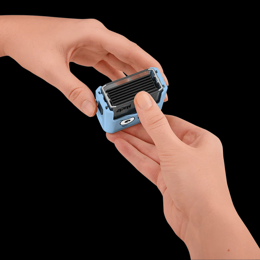 Small blue electronic device held between two hands against a black background