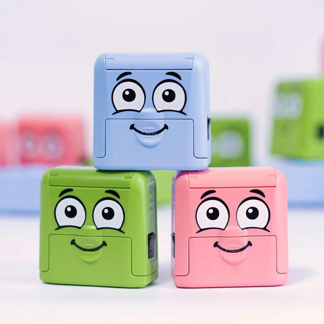 Three colorful blocks with cartoon faces on a light background