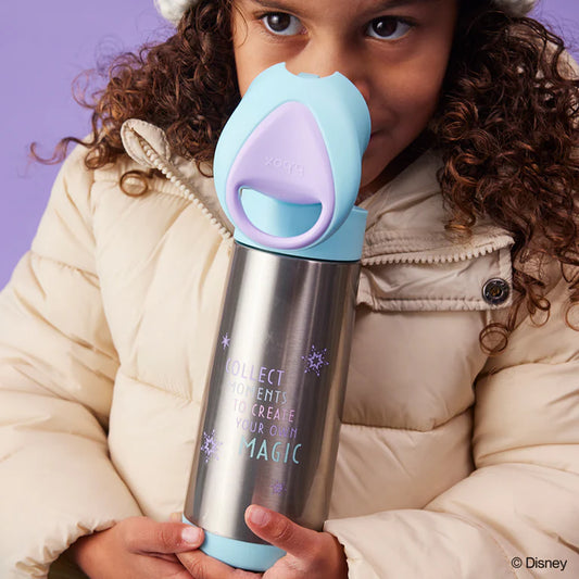 Child holding a silver water bottle with a colorful cap against a purple background