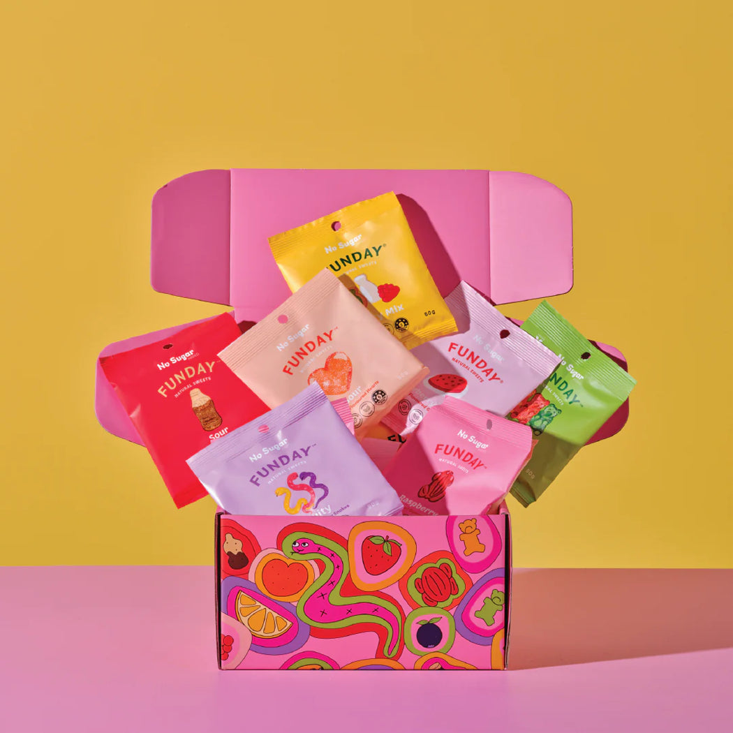 Colorful 'Funday' snack packages in a pink box on a yellow and pink background