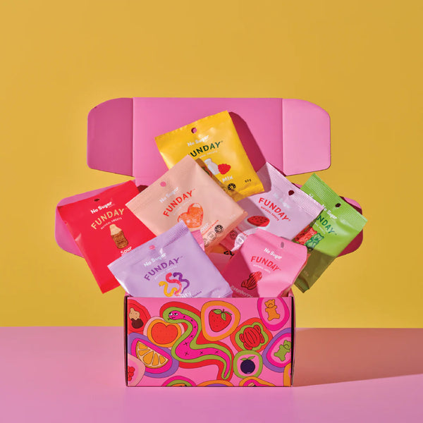 Colorful 'Funday' snack packages in a pink box on a yellow and pink background