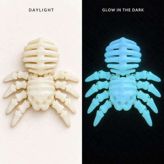 A split comparison of a spider-shaped object under normal light and glow-in-the-dark conditions. The left side labeled 'DAYLIGHT' shows the item in off-white/cream under normal lighting, and the right side labeled 'GLOW IN THE DARK' shows it glowing bright cyan-blue against a black background.