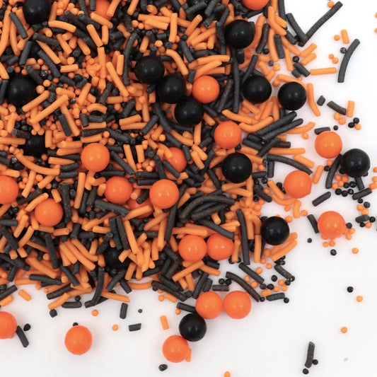 Halloween-themed sprinkles with orange and black colors on a white background