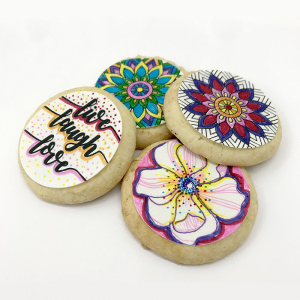 Decorative cookies with floral designs and text on a white background