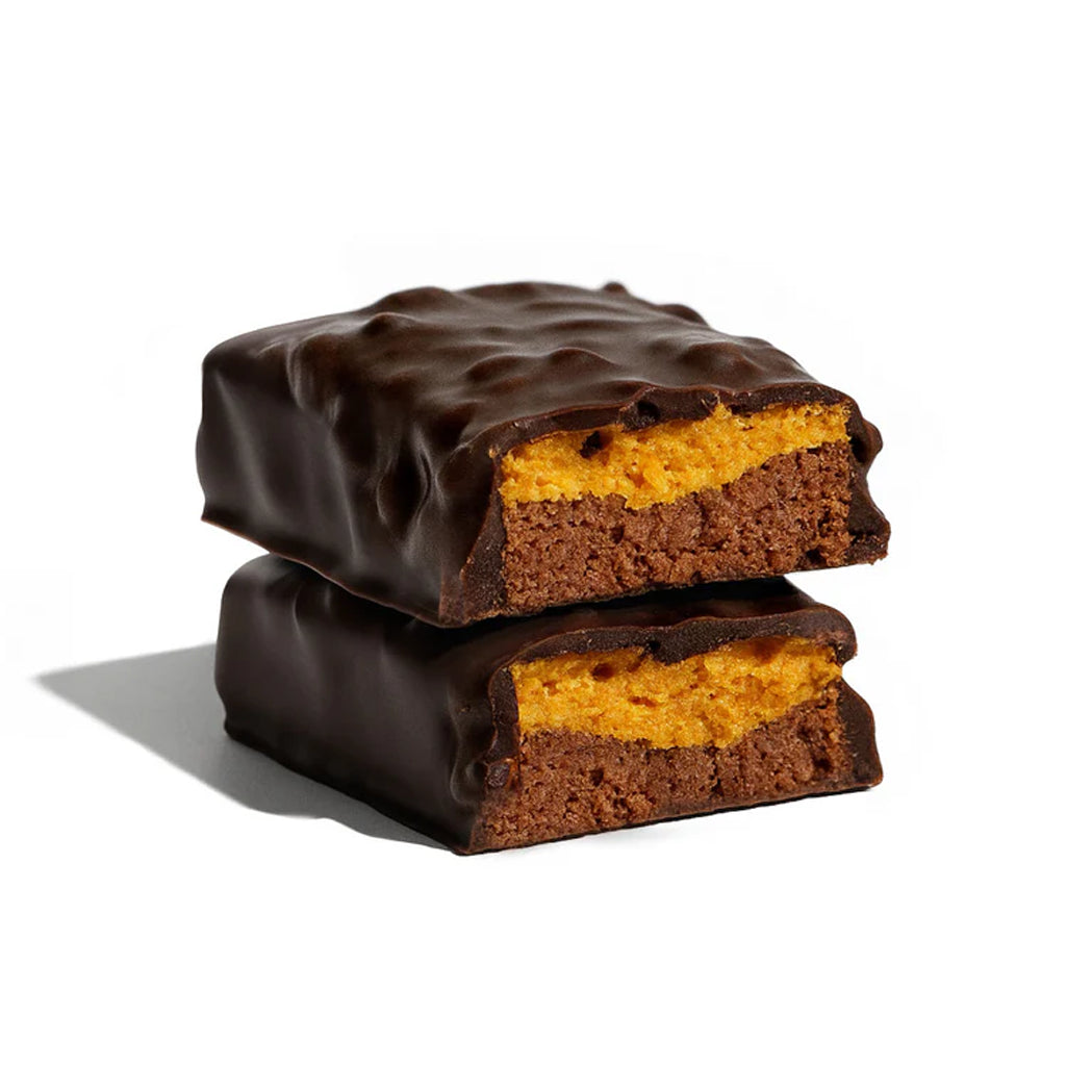 Two chocolate-covered brownie bars stacked on a white background