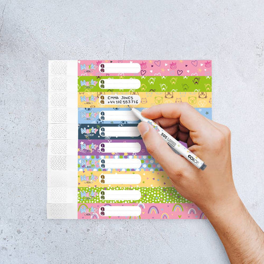 Colorful label sheet with a hand holding a marker on a light gray background