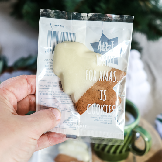 Hand holding a package of cookies with a Christmas-themed message.
