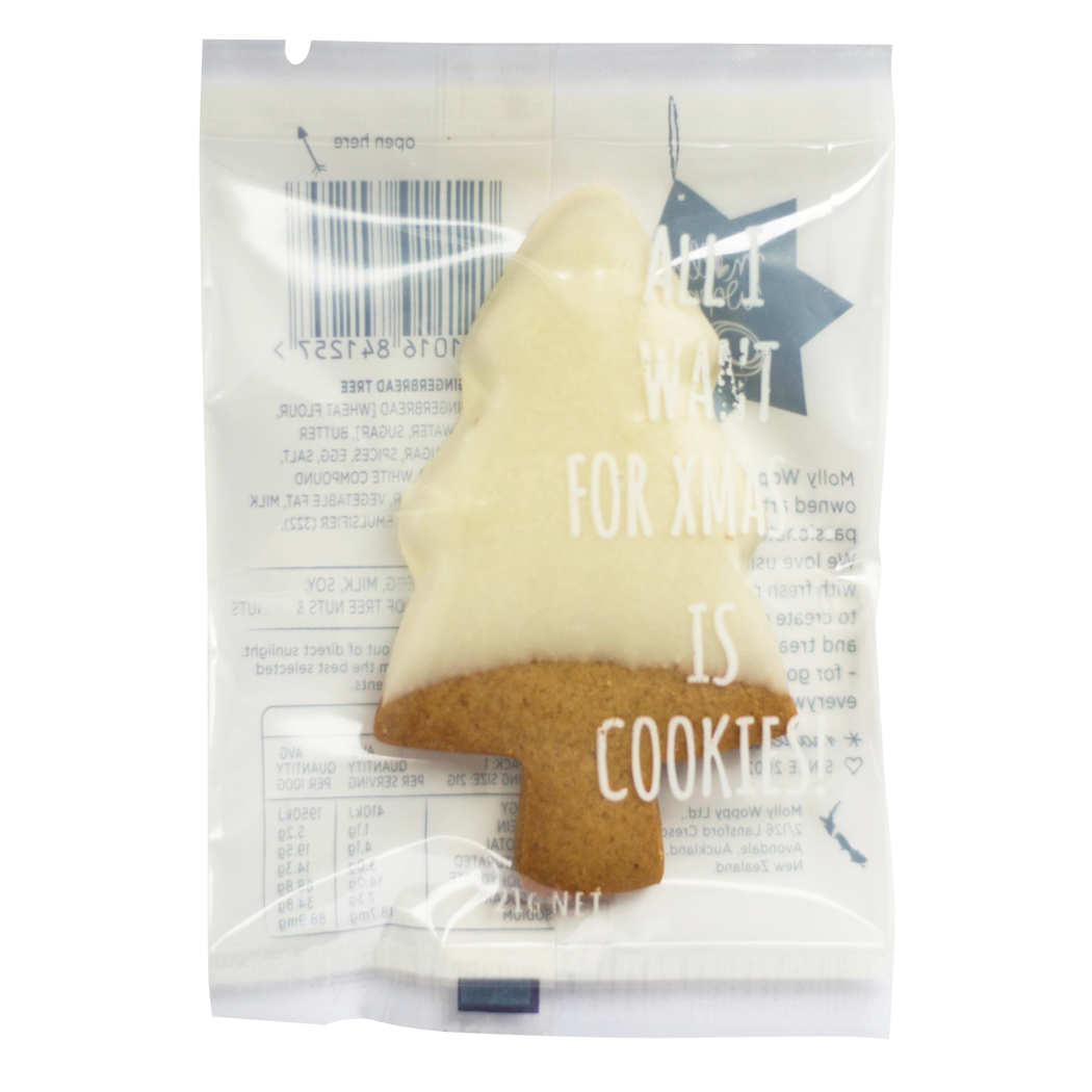 Tree-shaped cookie with white icing and brown base in a clear packaging bag.