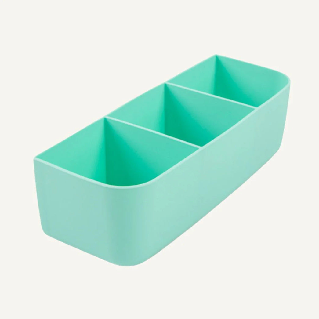 Mint green rectangular container with four compartments on a light gray background