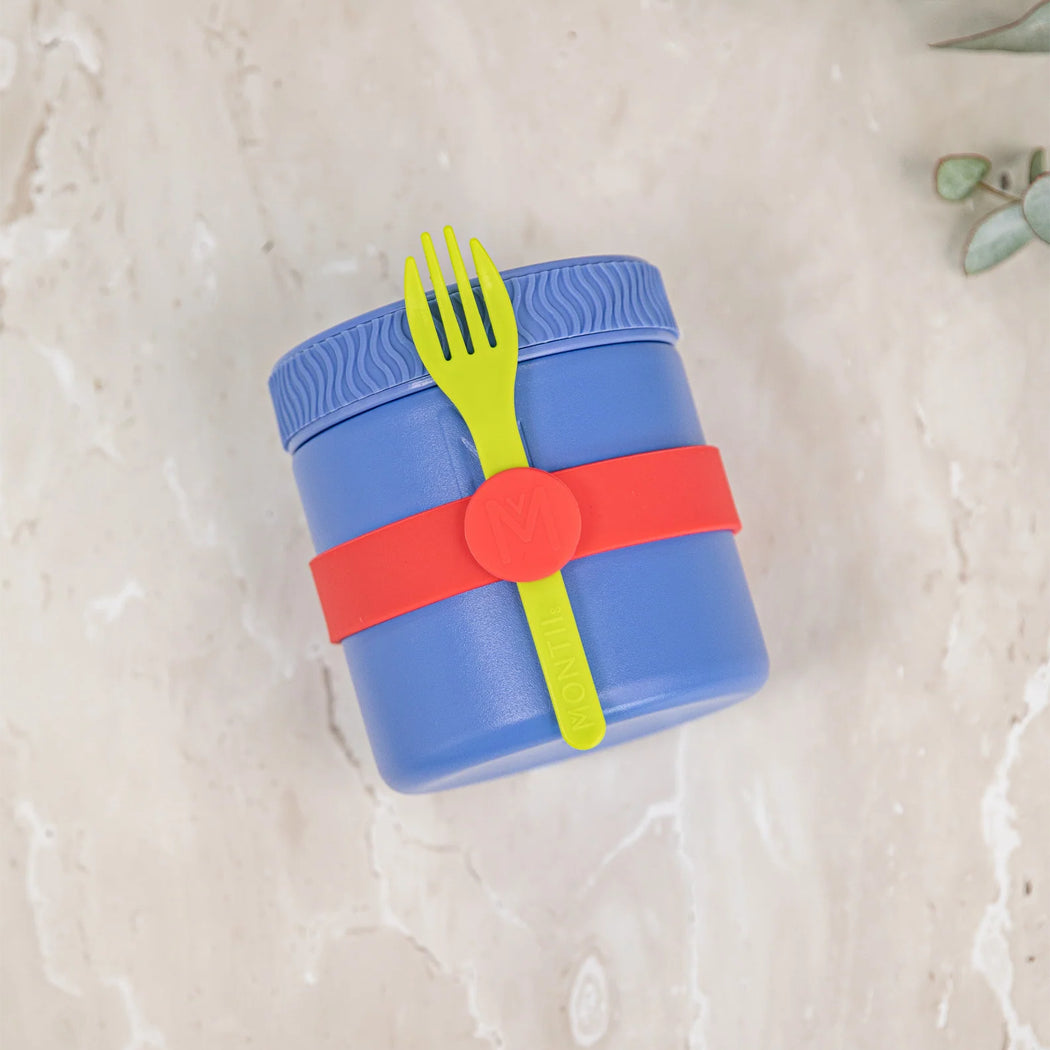 Blue lunch container with a green fork and red strap on a light beige background