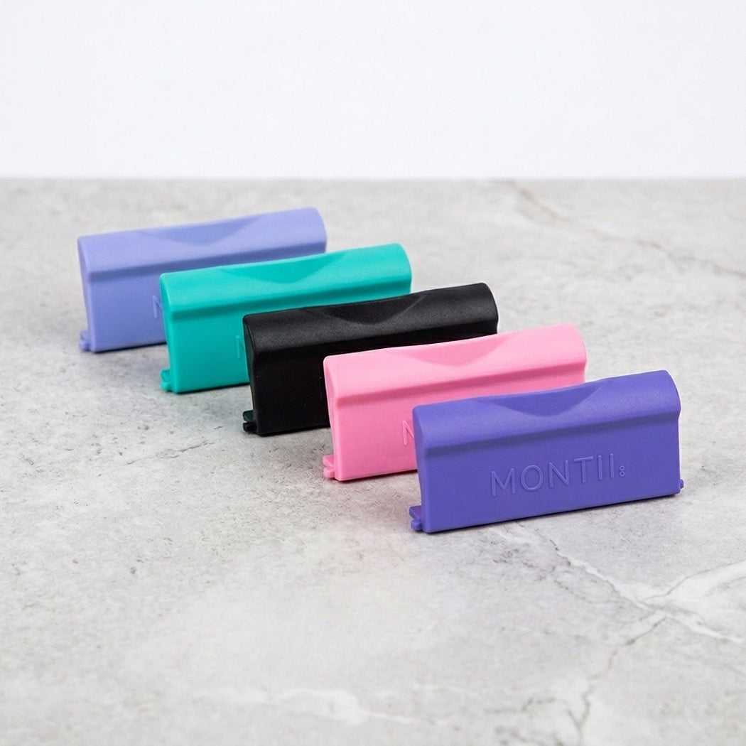 Five replacement latches in different colours on a light grey surface, with 'MONTII' branding.