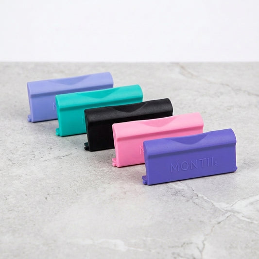 Five replacement latches in different colours on a light grey surface, with 'MONTII' branding.