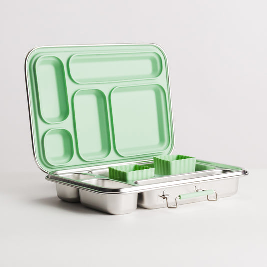 A stainless steel bento lunch box with a mint green interior and lid, shown open with compartments and small matching green silicone food containers inside, on a light gray background.