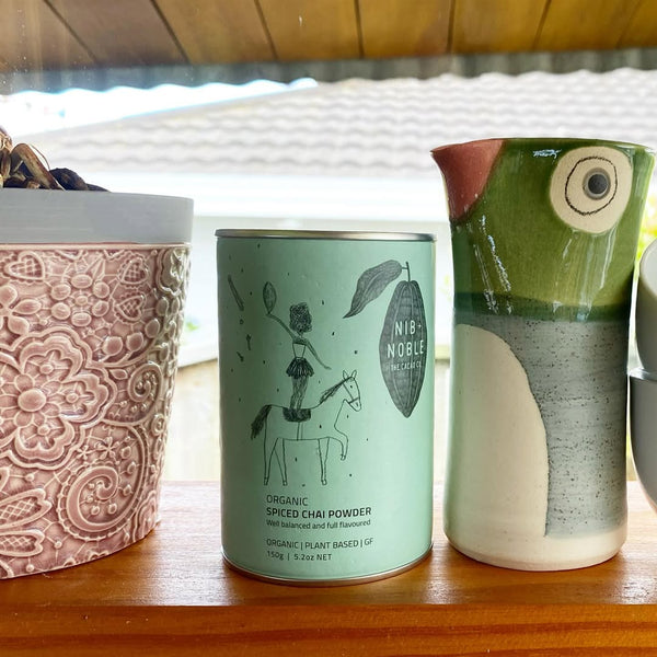 Three ceramic items on a wooden surface with a blurred background