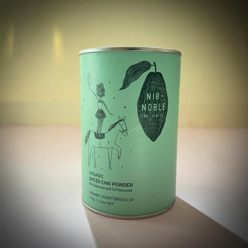 Green canister with 'Nib Noble' branding on a light background